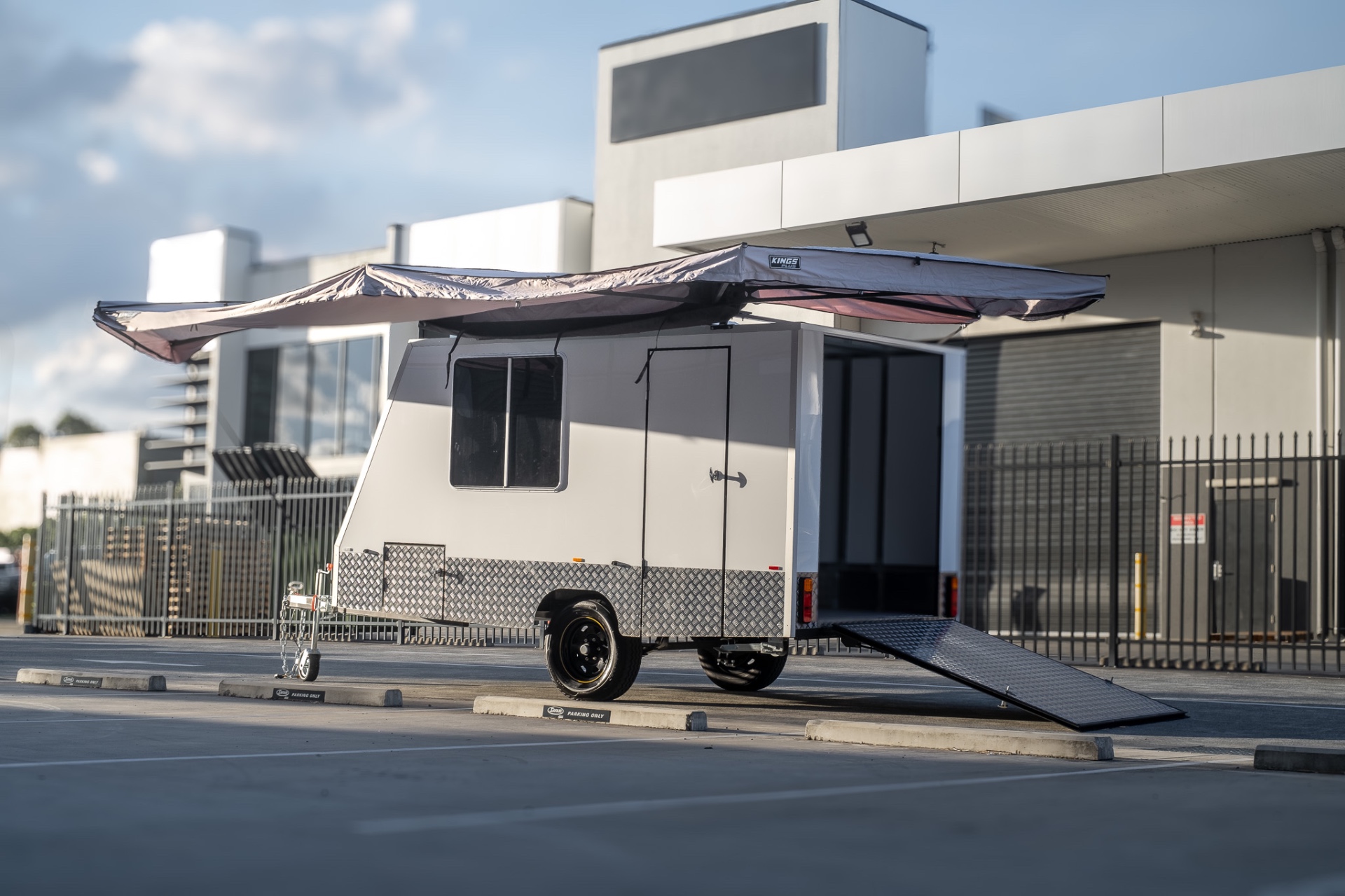MotoCampers 001 enclosed trailer with awning extended and rear ramp down on the Gold Coast